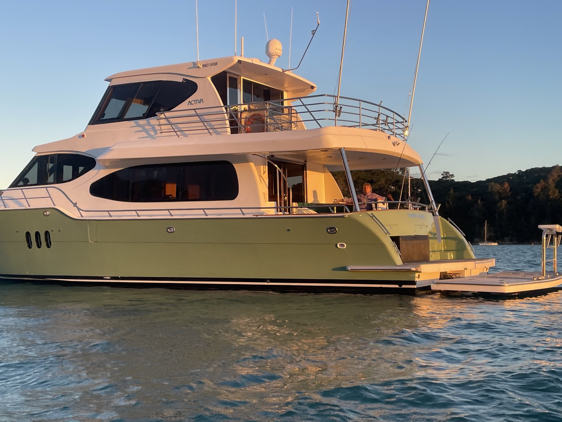 The Thirsty Whale at anchor in golden evening light near Waiheke Island