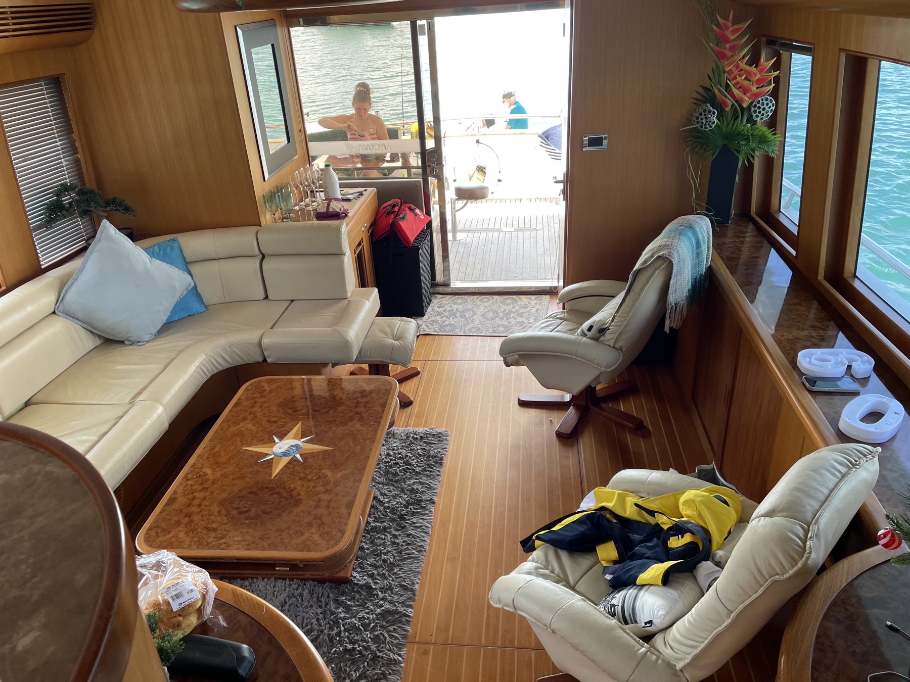 The main saloon of the Thirsty Whale with leather seating, opening to the swim platform